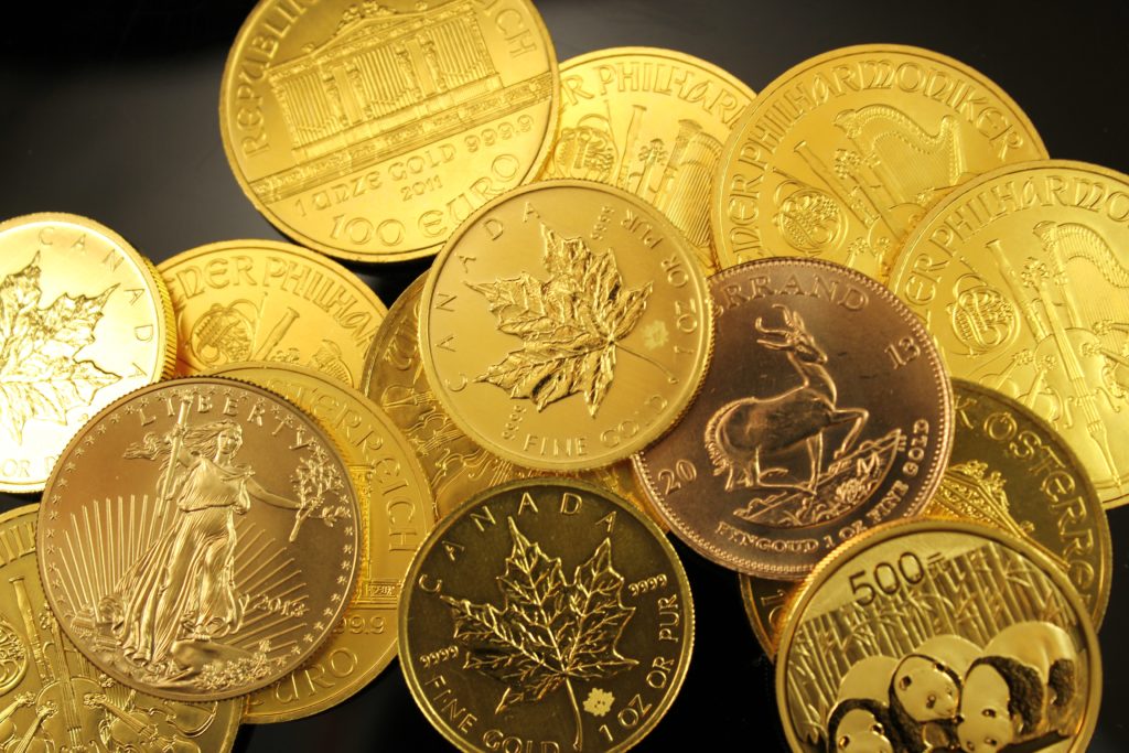 various gold coins on black background